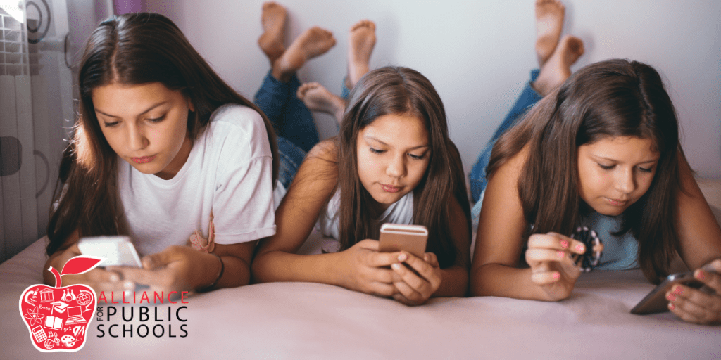 photo of three girls on their phones